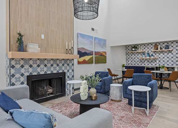 A living room with a fireplace and a painting on the wall.