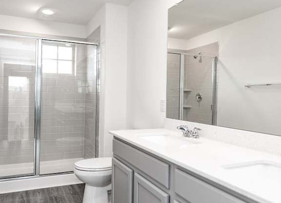 a bathroom with a toilet sink and shower
