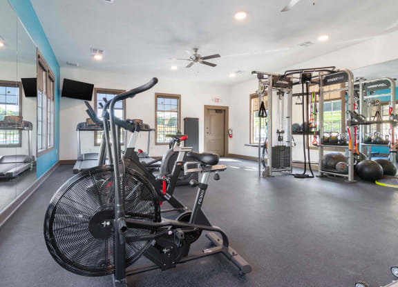 a home gym with exercise equipment and a bike in it