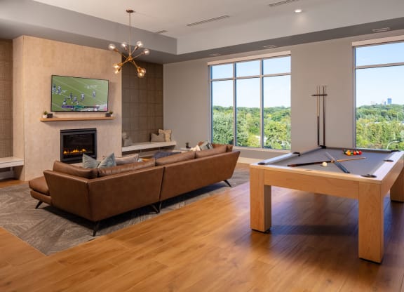a living room with a pool table and a flat screen tv
