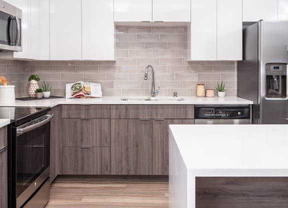 a kitchen with white countertops and wooden cabinets