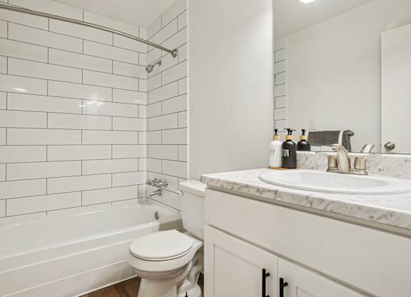 Renovated bathroom with subway-tile shower and modern vanity at Willowstone Apartments in Southeast Denver.