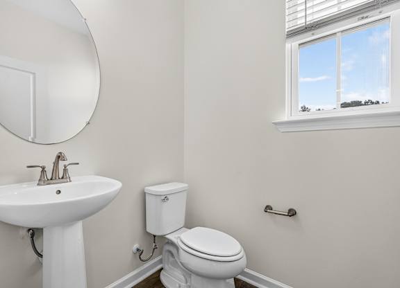 A white sink and toilet in a bathroom.