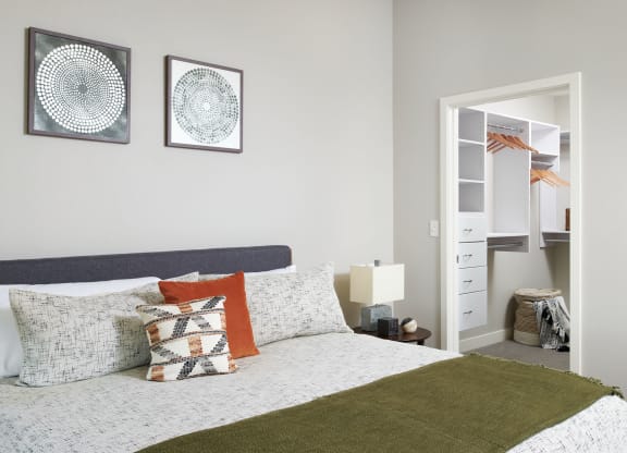 a bedroom with a bed and two pictures on the wall