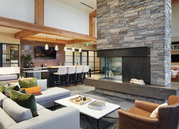 a living room filled with furniture and a large fireplace