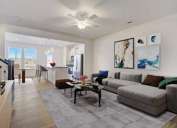 A modern living room with a grey sofa and a coffee table.