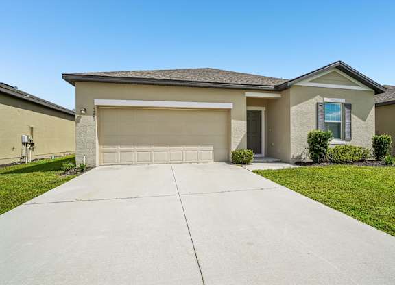A house with a garage and a driveway.
