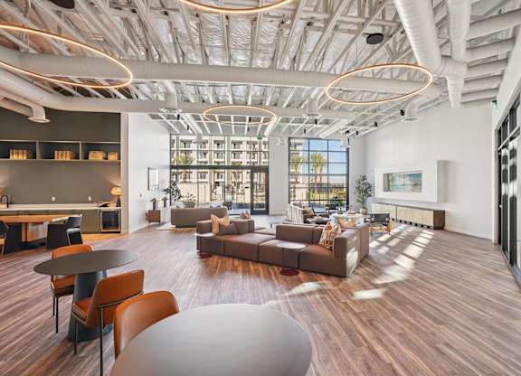 A modern living room with a large window and a wooden floor.
