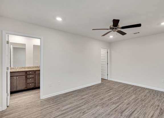 A room with a ceiling fan and lighting fixture.