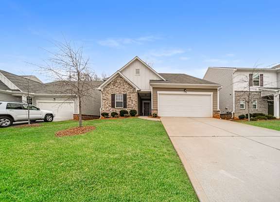 A house with a white garage door and a driveway.