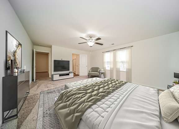 A bedroom with a large bed and a flat screen TV.