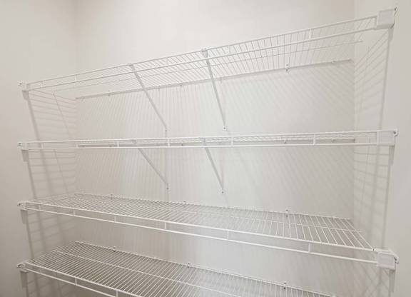 Empty wire shelving unit in a room.