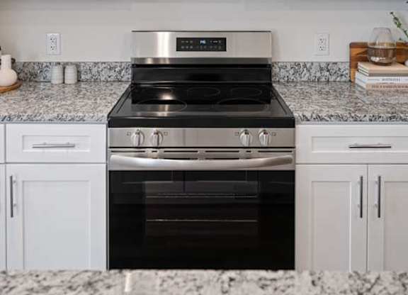A kitchen with a stove and microwave.