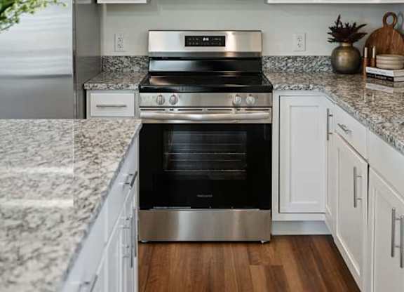 A kitchen with a stainless steel oven and microwave.
