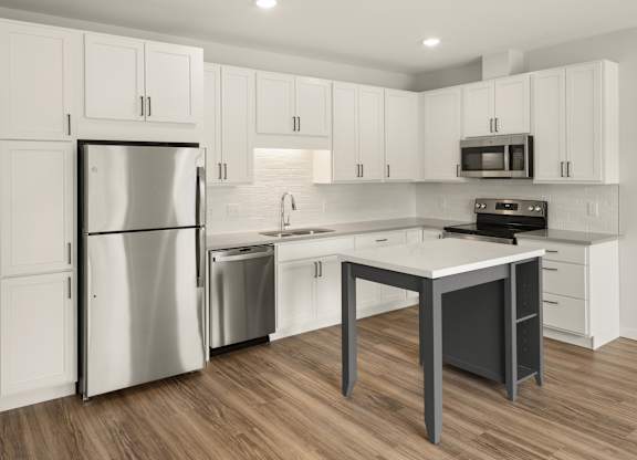 A modern kitchen with a stainless steel refrigerator and a white island.