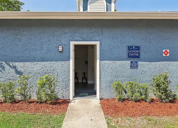 A blue building with a sign that says Laundry Center.