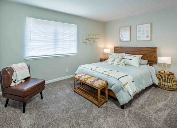 Large bedroom with big window providing natural light at Grand Arbor Reserve Apartments in Raleigh, NC 27607, near Central Raleigh.