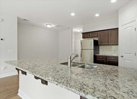 A kitchen with granite countertops and stainless steel appliances.