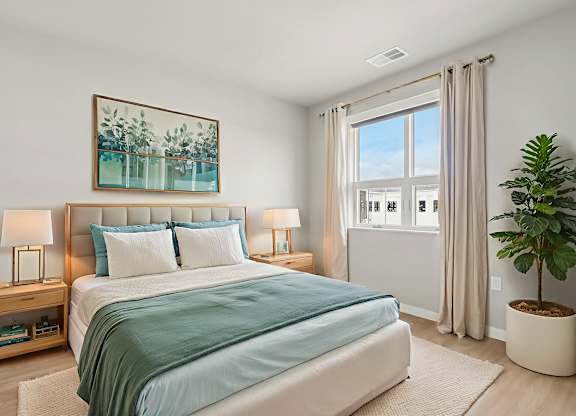A bedroom with a large bed and a painting above it.