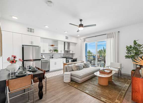 A modern kitchen with a dining table and chairs.