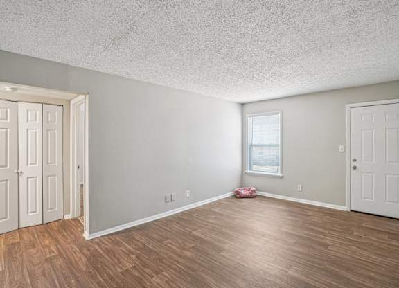 A room with wooden floors and white walls.