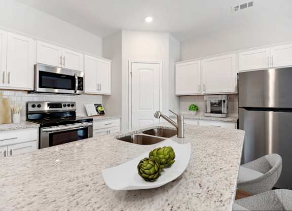 Cottonvale Towns in Savannah, GA photo of a large kitchen with stainless steel appliances and granite counter tops