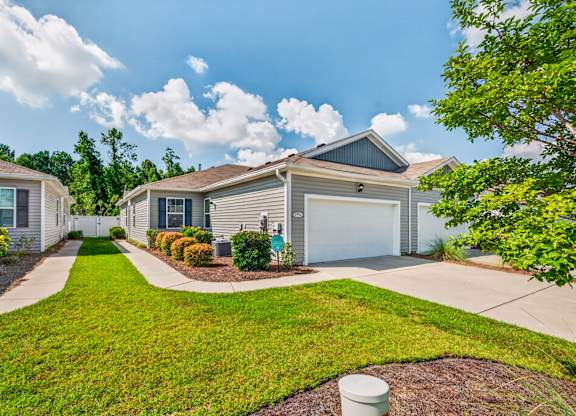A residential house with a garage and a driveway.