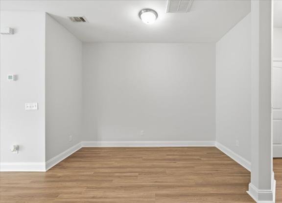 A room with wooden floors and white walls.