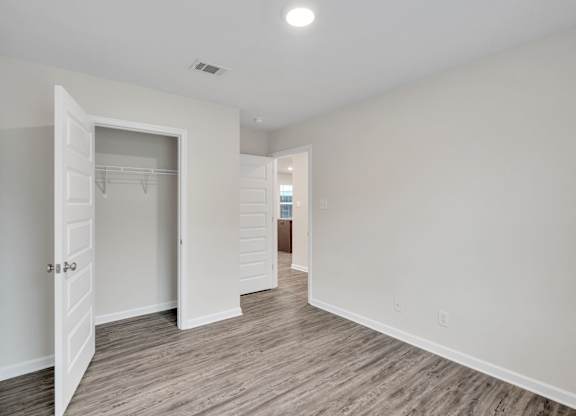A room with a white door and a white wall.