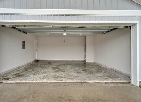 A garage with a concrete floor and white walls.