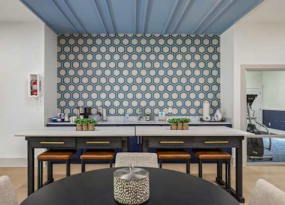 A dining room with a table and chairs.