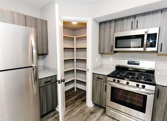 a renovated kitchen with stainless steel appliances and wooden cabinets