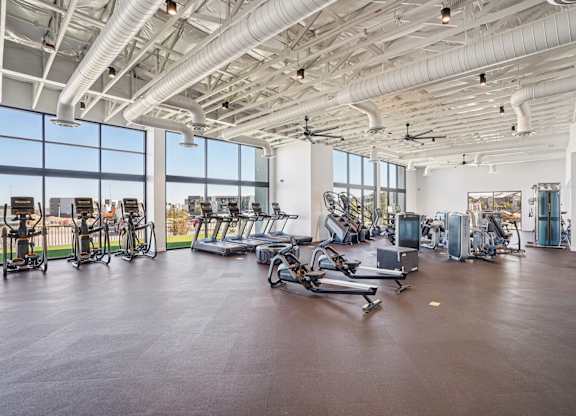 A gym with a variety of exercise equipment.