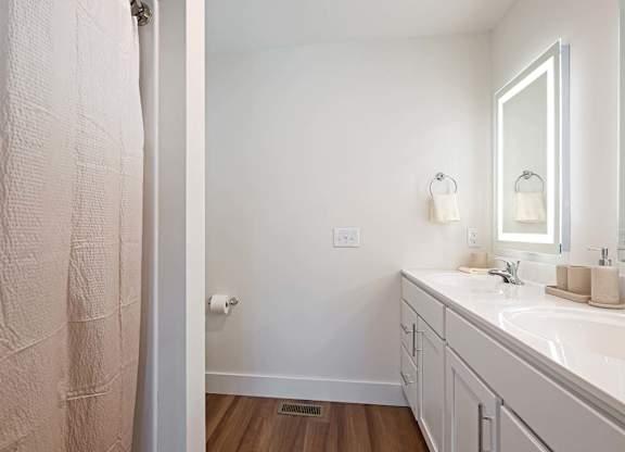 A bathroom with a white sink and a mirror.
