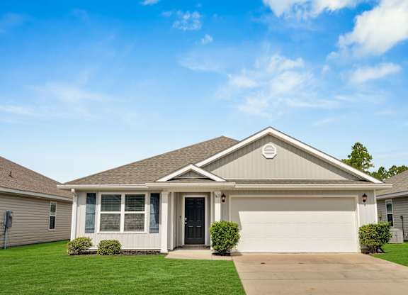 A house with a grey roof and a black door.