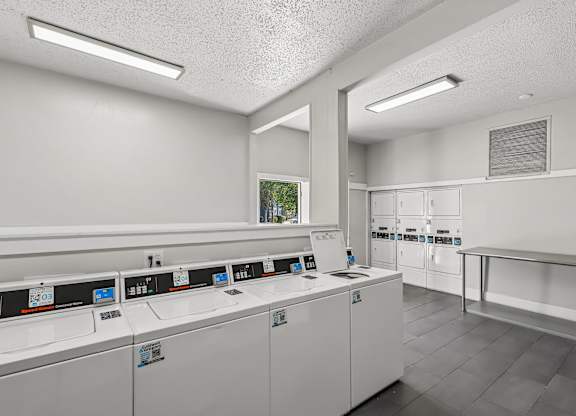 A laundromat with rows of washers and dryers.