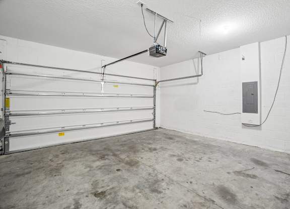 A garage with a white wall and a white ceiling.
