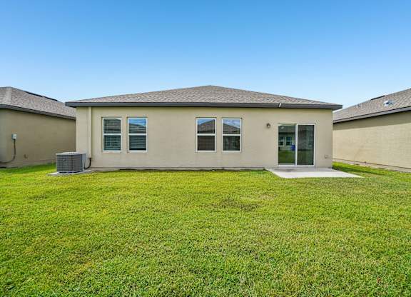 A house with a green lawn in front.