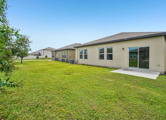 A house with a green lawn in front.