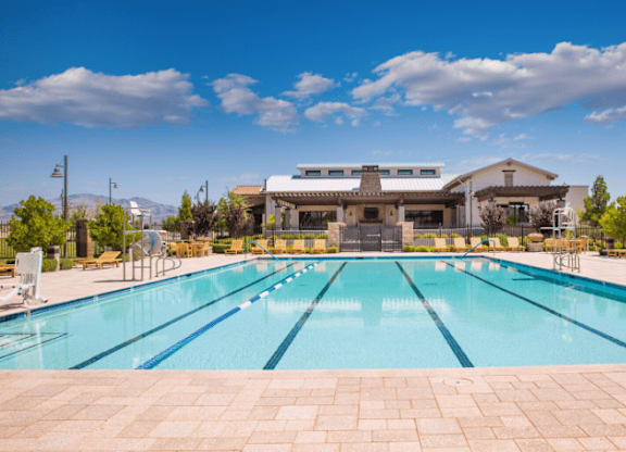 A large outdoor swimming pool with a building in the background.