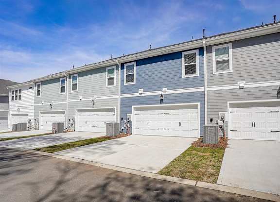 a blue house with a white garage door