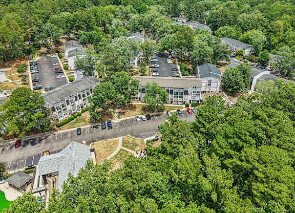 A bird's eye view of a residential area with houses and cars.