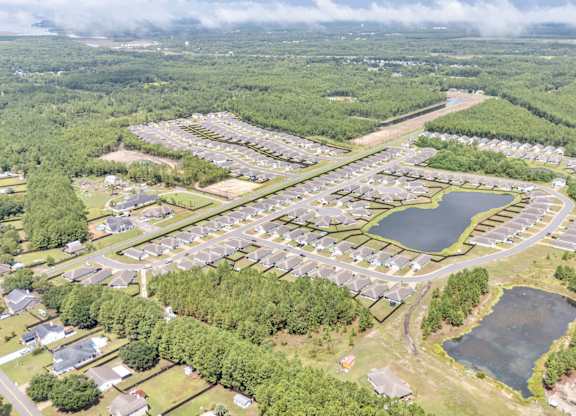 An aerial view of a residential area with a large lake in the middle.