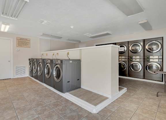 Addison Lane Apartment homes in Gainesville Florida photo of photo of washer and dryers in a laundry room