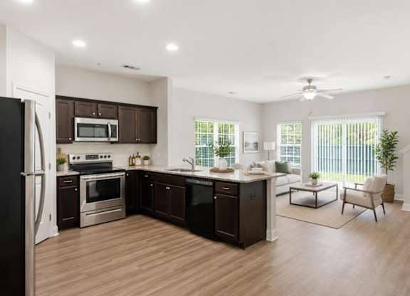 A modern kitchen with dark brown cabinets and stainless steel appliances.