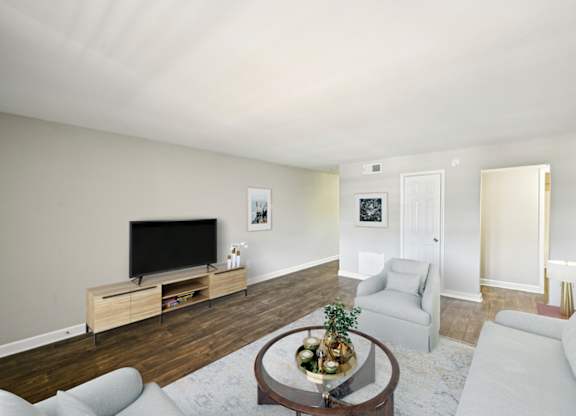 Living room with light gray walls, dark wood floors, and modern furniture.