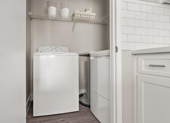 A white dishwasher is open in a kitchen.