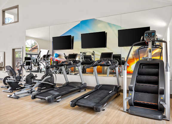 A gym with treadmills and exercise bikes.