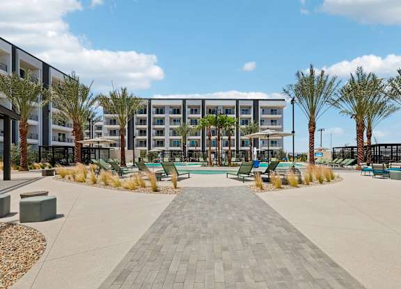 A large building with a pool in front of it.