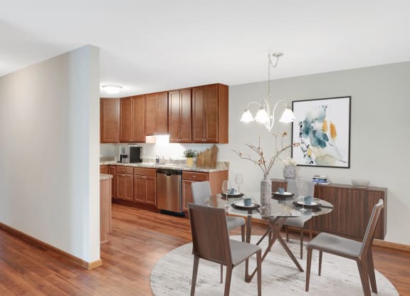 Laurel West End Apartments in Golden Valley, MN photo of a dining area with a table and chairs and a kitchen in the background